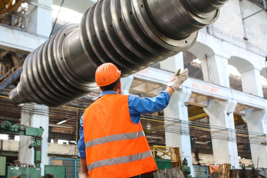 man standing near gray metal equipment